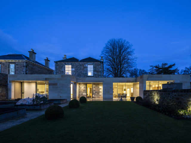 Edinburgh garden villa extension - External night time view of rear elevation.